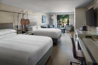 a hotel room with two beds and a desk at Orlando World Center Marriott in Orlando