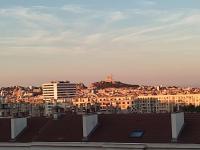 a city with buildings and a hill in the background at Appartement de 55m2 climatisé à 6 min du tram in Marseille
