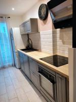 a kitchen with a sink and a refrigerator at Appartement de 55m2 climatisé à 6 min du tram in Marseille