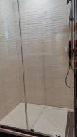 a shower with a glass door in a bathroom at Appartement de 55m2 climatisé à 6 min du tram in Marseille