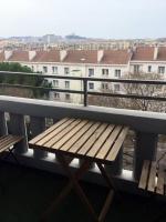 a wooden bench sitting on top of a balcony at Appartement de 55m2 climatisé à 6 min du tram in Marseille