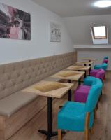 a row of tables and chairs in a room at Apartments Ozren in Soko Banja