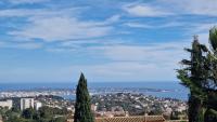 a view of the city from a hill with trees at Beautiful Sea View House in Vallauris