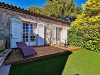 a wooden deck with a purple chair on a yard at Beautiful Sea View House in Vallauris