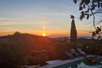 a sunset over a villa with a swimming pool at Beautiful Sea View House in Vallauris