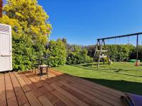 a wooden deck with a swing and a playground at Beautiful Sea View House in Vallauris