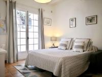 a bedroom with a bed and a large window at Beautiful Sea View House in Vallauris