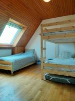 a bedroom with two bunk beds and a window at Calme et lumière à 2 pas de la mer in Plouescat