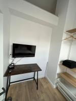 Televízia a/alebo spoločenská miestnosť v ubytovaní Le Central 3 - Pépite en centre ville d’Elbeuf