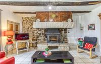 a living room with a fireplace and a table at Gorgeous Home In Pierrefiche With House A Panoramic View in Pierrefiche