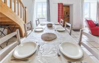 a dining room with a table with white plates and wine glasses at Gorgeous Home In Pierrefiche With House A Panoramic View in Pierrefiche