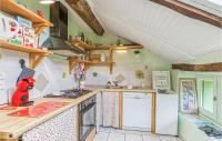 a small kitchen with a stove and a refrigerator at Gorgeous Home In Pierrefiche With House A Panoramic View in Pierrefiche