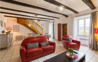 a living room with two red chairs and a table at Gorgeous Home In Pierrefiche With House A Panoramic View in Pierrefiche