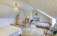 a attic bedroom with two beds and a table at Gorgeous Home In Pierrefiche With House A Panoramic View in Pierrefiche