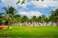 a park with palm trees on the beach at Thiên Tân Hotel in Con Dao