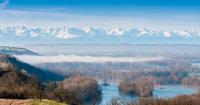 a view of a river with snowy mountains in the background at Le Lamartine - T3 dans un parc in Frouzins