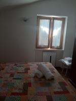 Łóżko lub łóżka w pokoju w obiekcie Casa Vacanze Fortini