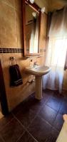 a bathroom with a sink and a mirror at Ta Majsi farmhouse with indoor heated pool in San Lawrenz