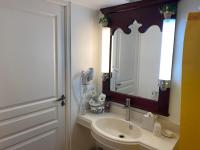 a bathroom with a sink and a toilet and a mirror at Pierre et Vacances Vue Mer in Sainte-Luce