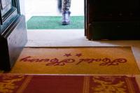 a door with the words happy poop written on the door mat at Hotel Henry in Venice