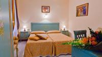 a bedroom with a bed with a orange bedspread at Hotel Henry in Venice