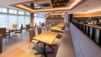 a restaurant with wooden tables and chairs and a bar at Onn Yuda Onsen in Yamaguchi