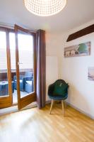 a room with a chair and a glass door at La couronne Maison 80m2 garage &amp; terrasse in Sainte-Croix-en-Plaine