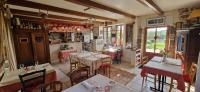 a restaurant with tables and chairs in a room at Auberge De Bel Air in Brélès