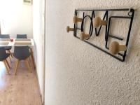 a dining room with a table and a wall at L&#39;appartement du Centre in Chalons en Champagne