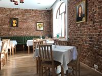 a dining room with tables and a brick wall at Casa Del Sole in Alba Iulia