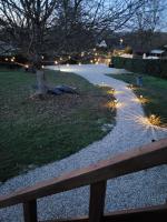 a walkway with a tree with lights on it at La paillote idyllique in Faverolles-sur-Cher