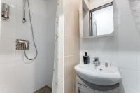 a white bathroom with a sink and a shower at L&#39;Oasis Montparnasse in Paris