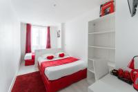 a bedroom with a red and white bed and shelves at L&#39;Oasis Montparnasse in Paris