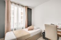 a small bedroom with a bed and a window at L&#39;Oasis Montparnasse in Paris