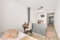 a bedroom with a desk and a bed in a room at L&#39;Oasis Montparnasse in Paris