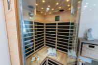 a sauna with glass doors and white shoes in it at Gîte l&#39;Améthyste 3 appartements in Gérardmer
