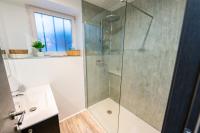 a bathroom with a shower with a glass door at Gîte l&#39;Améthyste 3 appartements in Gérardmer