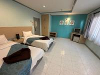 Postel nebo postele na pokoji v ubytování Thipurai City Hotel