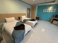 Postel nebo postele na pokoji v ubytování Thipurai City Hotel