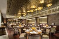 a dining room with tables and chairs and chandeliers at Pullman Resort Xishuangbanna in Jinghong