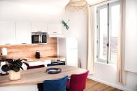 a kitchen with a table and chairs and a window at Résidence Pompidou Libourne in Libourne