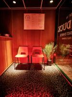 two red chairs in a room with a wall at The 1852 Hotel - Self Check-in in Belfast