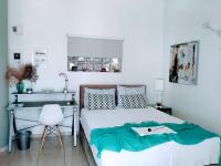 A bed or beds in a room at Vacations in Patra Studios