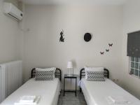 A bed or beds in a room at Vacations in Patra Studios