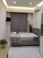 A bed or beds in a room at Vacations in Patra Studios