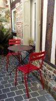 two red chairs and a table on a patio at Lovely cottage in Honfleur center in Honfleur