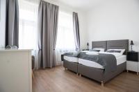 a bedroom with two beds and two windows at Residence St Havel Prague Old Town in Prague