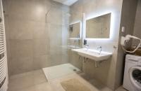a bathroom with a sink and a washing machine at Residence St Havel Prague Old Town in Prague