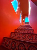 a staircase in a room with orange walls at Raid Garden Boutique Hotel in Magong