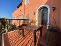 a patio with a wooden table and a building at Raid Garden Boutique Hotel in Magong